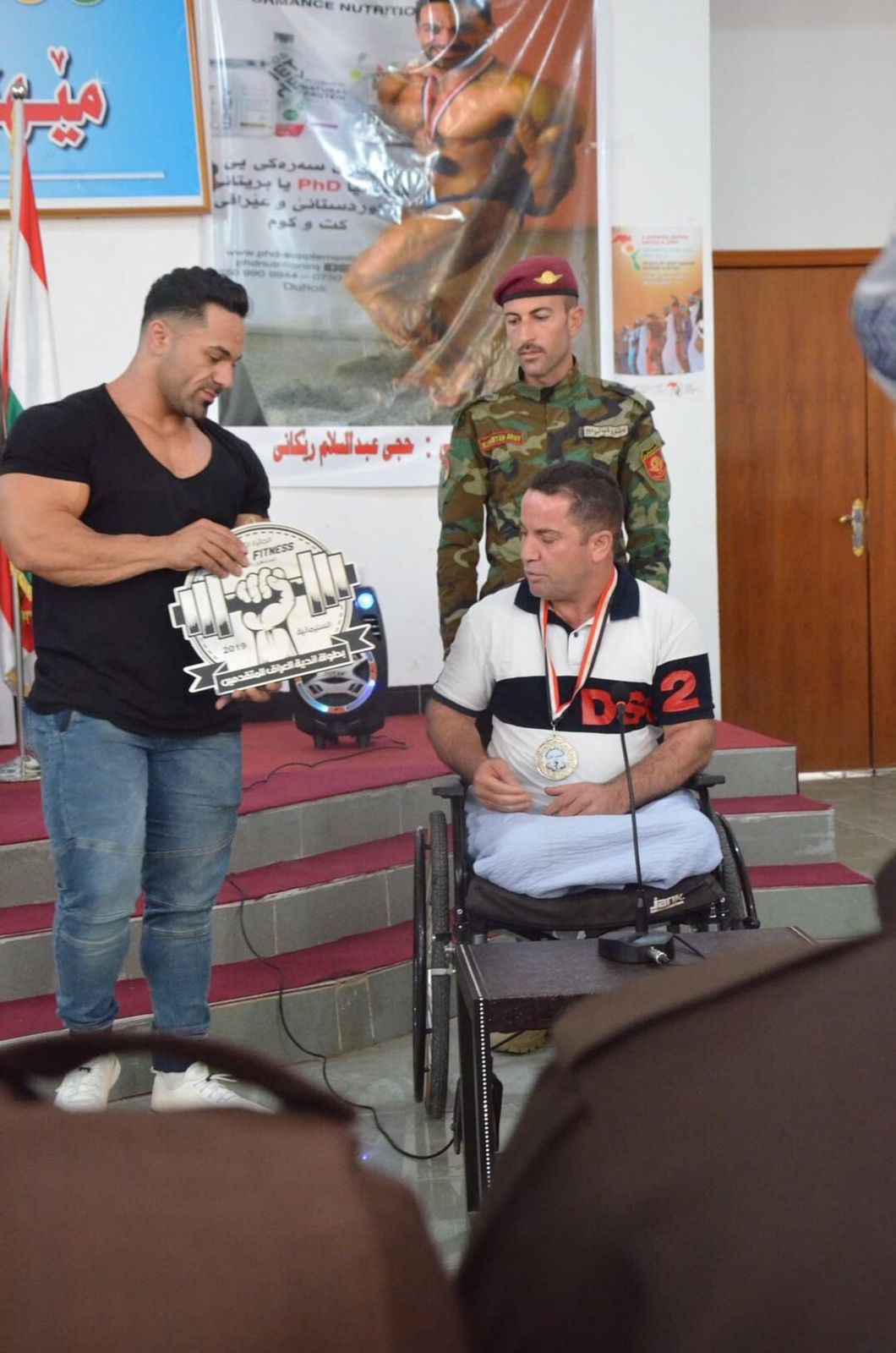 Haji Rekani honoring an injured Peshmerga. (Photo: Haji Rekani's archive) 